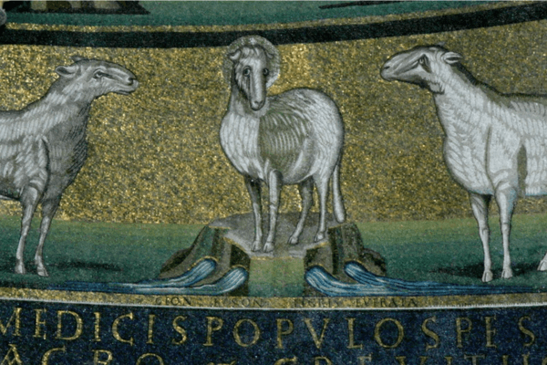 Religious mosaic showing three white sheep on green ground against a gold background, above a Latin inscription.
