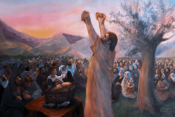 A watercolor pastel painting of Jesus' side profile as he holds up two halves of a loaf of bread in front of a wide crowd of onlookers sitting and gazing upon him. There's a tree to his right and mountains in the background, and a basket of bread loaves and a couple of fishes on a tree trunk in front of.